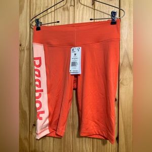 NWT - Reebok women’s size M bright orange bike shorts